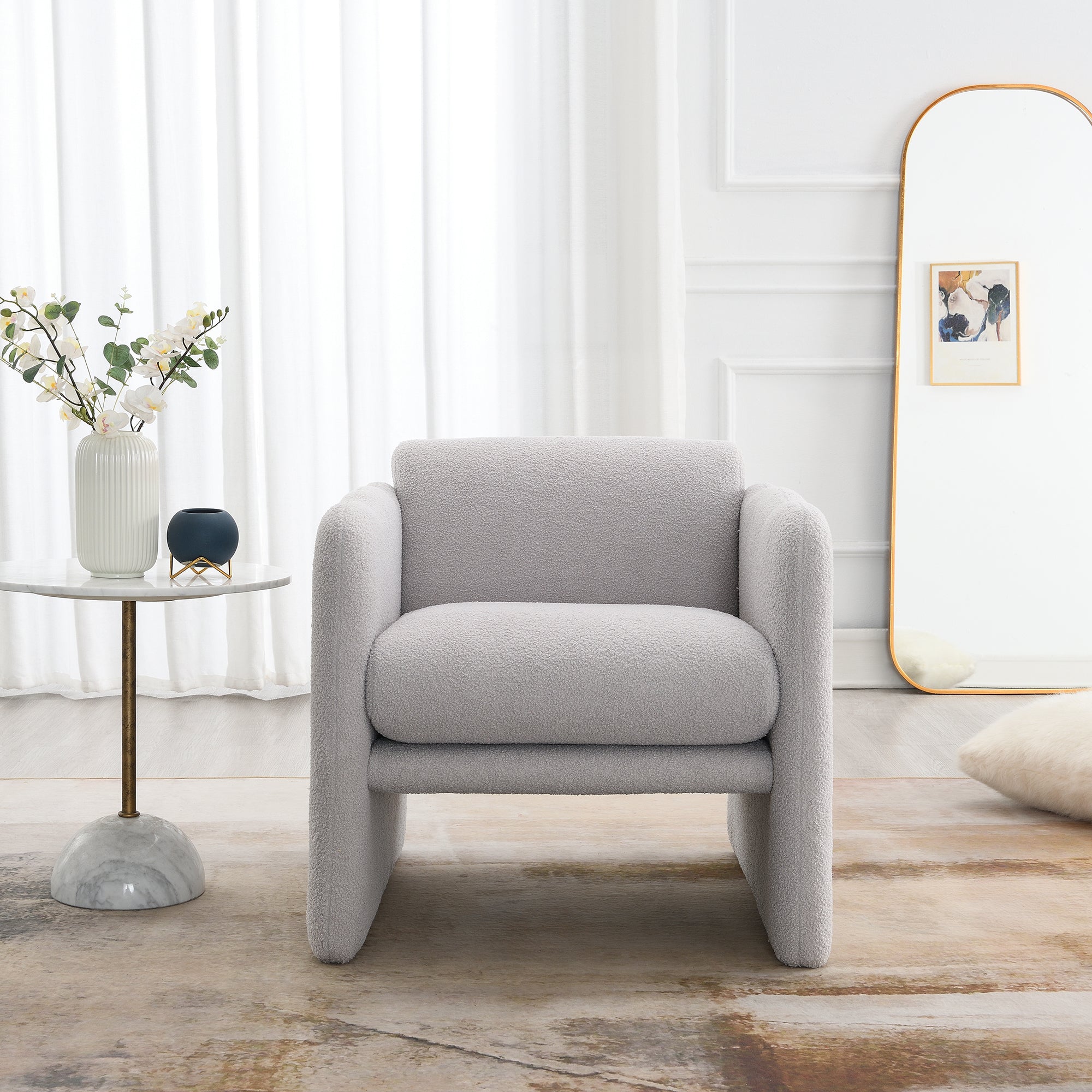 Accent chair with wavy armrests, metal decorations on both sides of the armrests, made of Teddy cloth, light gray